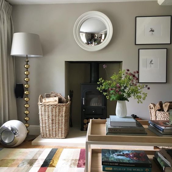 image white round mirror over fireplace