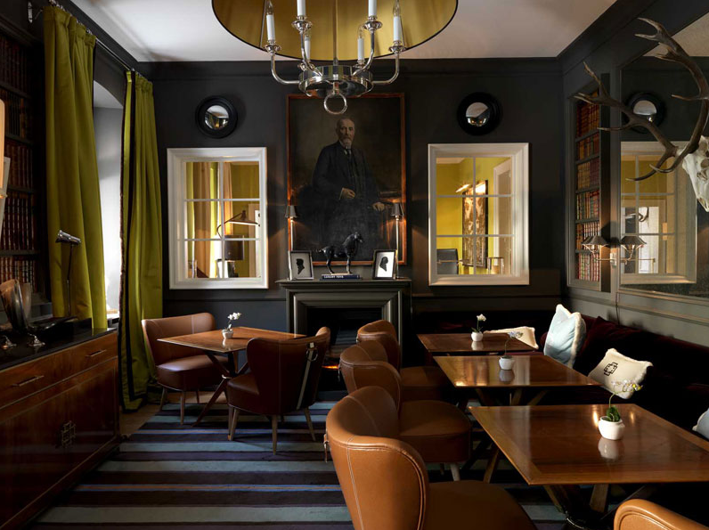 decorative convex mirrors with black frames hanging in a dining room