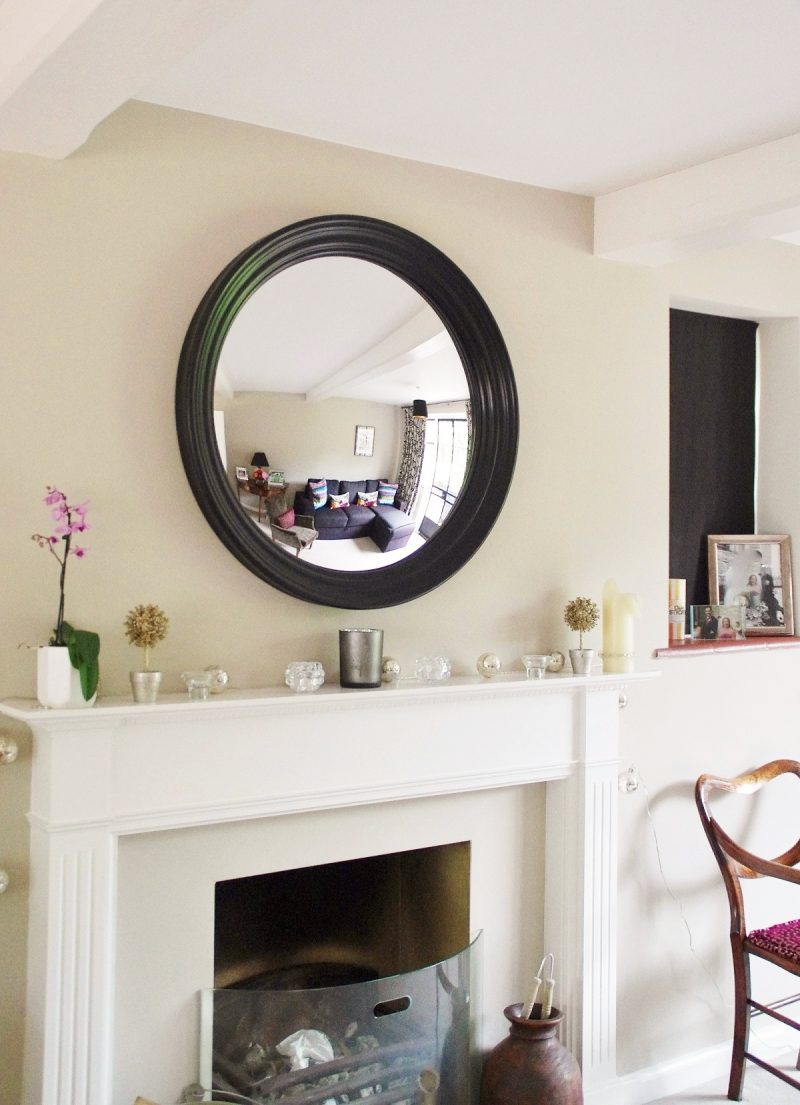 convex mirror black large Roma hanging a round mirror above a fireplace image