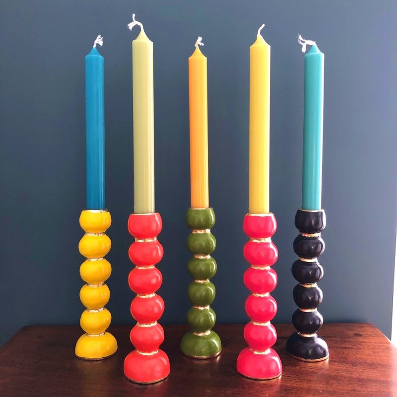 colourful bobbin candlesticks on a table image